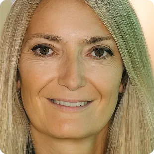 Close-up headshot of a smiling woman with long blonde hair, facing the camera