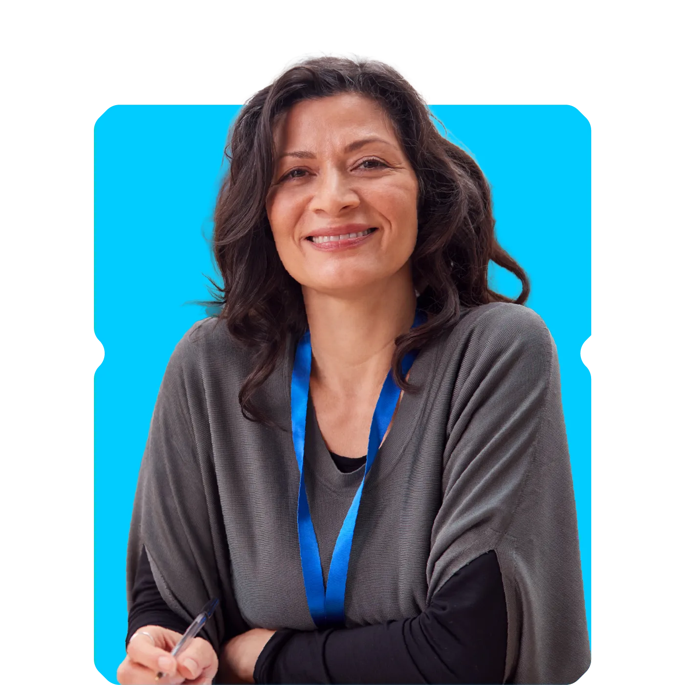 Smiling woman wearing a blue lanyard, holding a pen